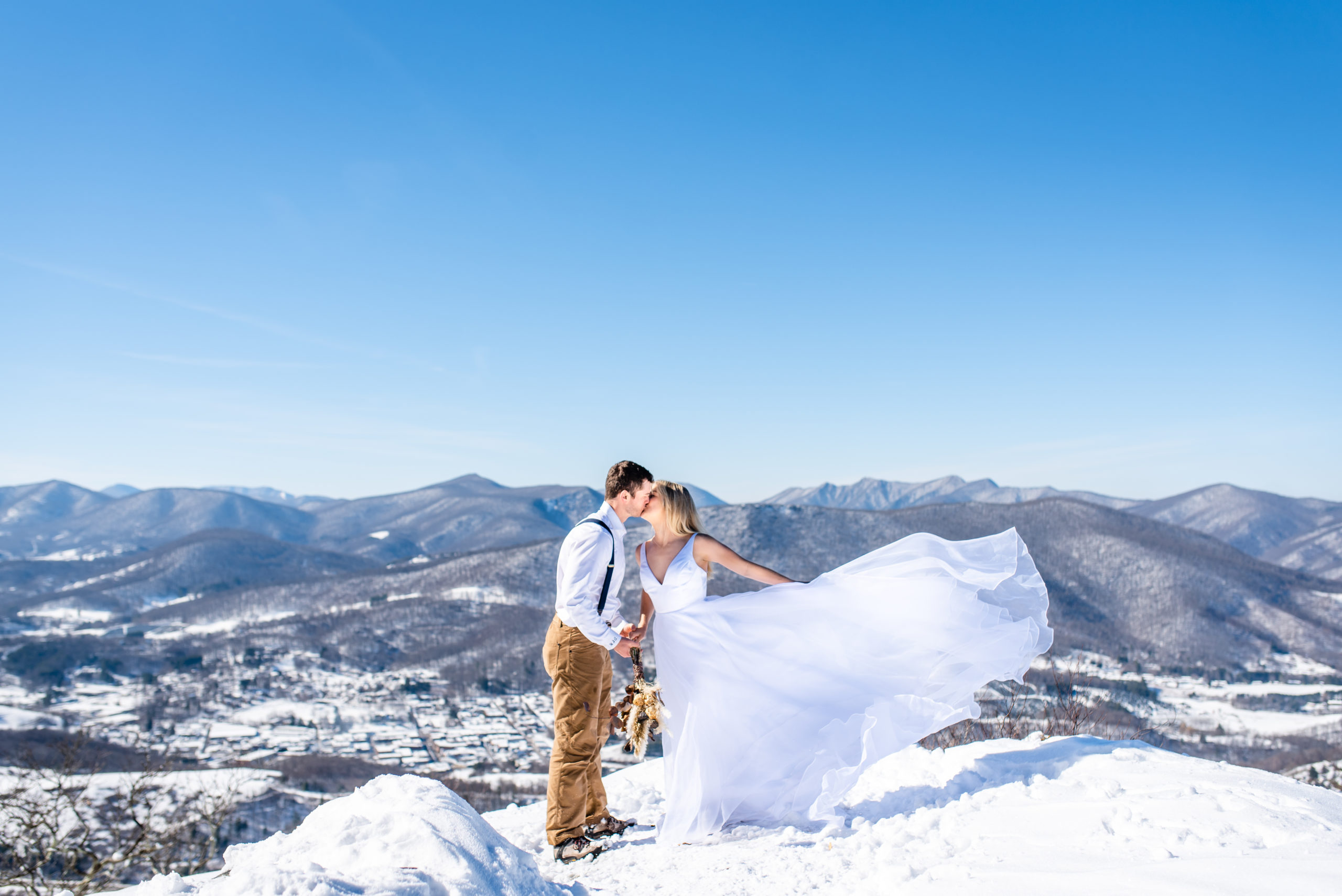 Eloping couple on a snowy overlook